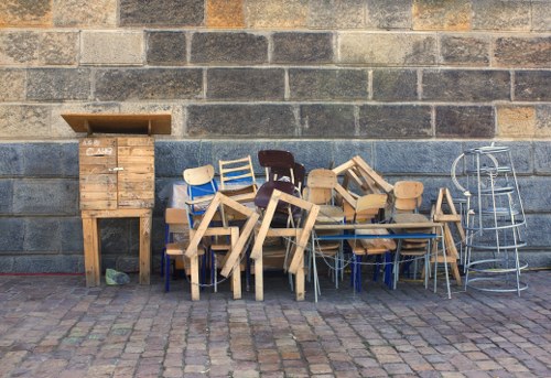 Professional loft clearance team organizing items in a Shadwell loft